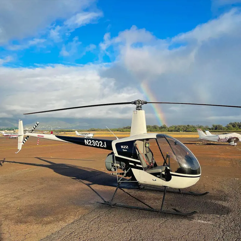 A R2 chopper from Go Fly Maui LLC with a rainbow in the background