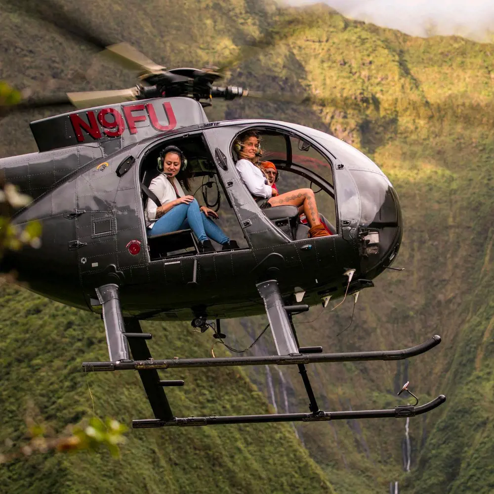 Passengers enjoy a private helicopter tour with doors off in Maui