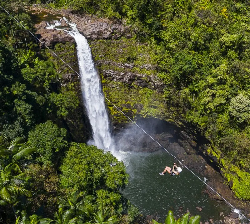 An aerial view of the zipline passing over the Kolekole Falls