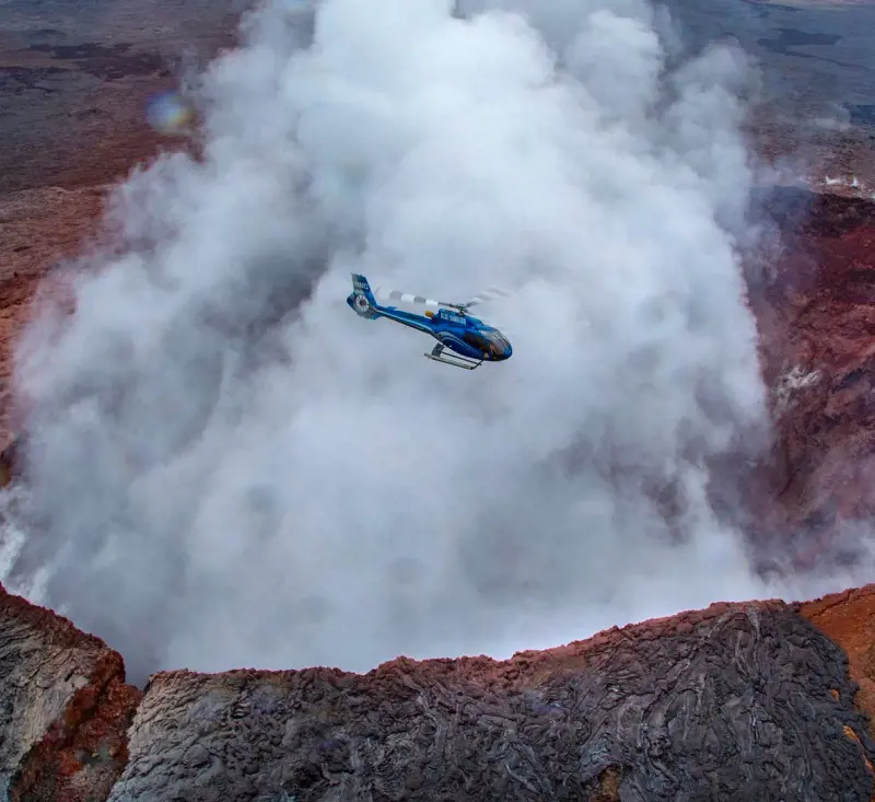 An amazing view of the Blue Hawaiian chopper flying over the volcano mountain in Hawaii