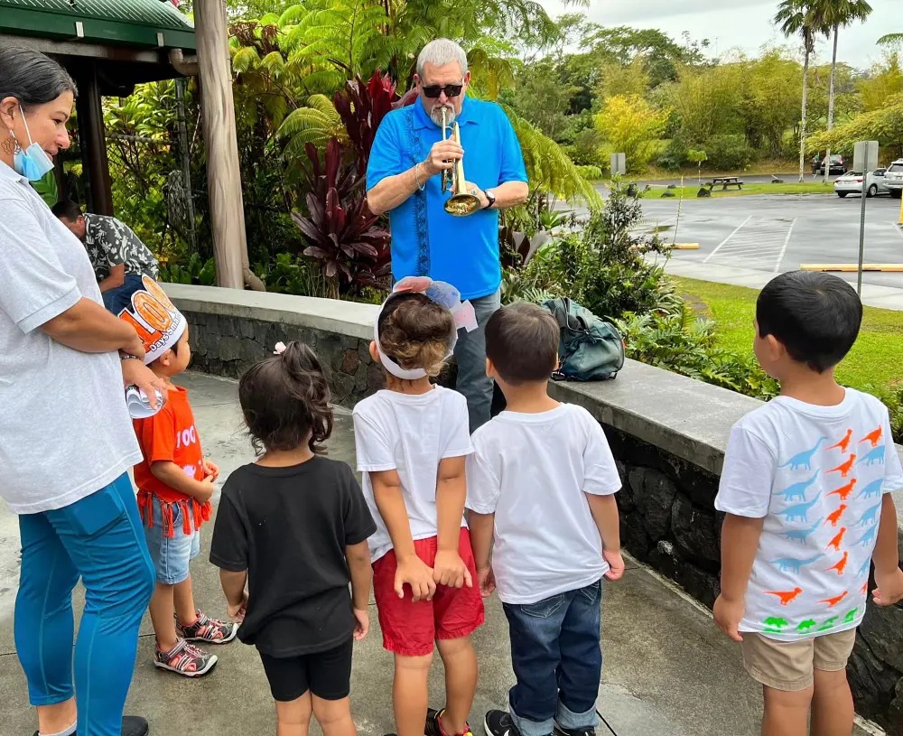 Children enjoying the performance from a musician at the Panaewa Zoo