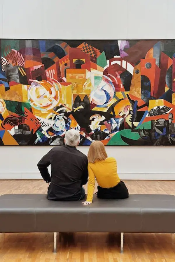 A couple looking at a painting at an art gallery