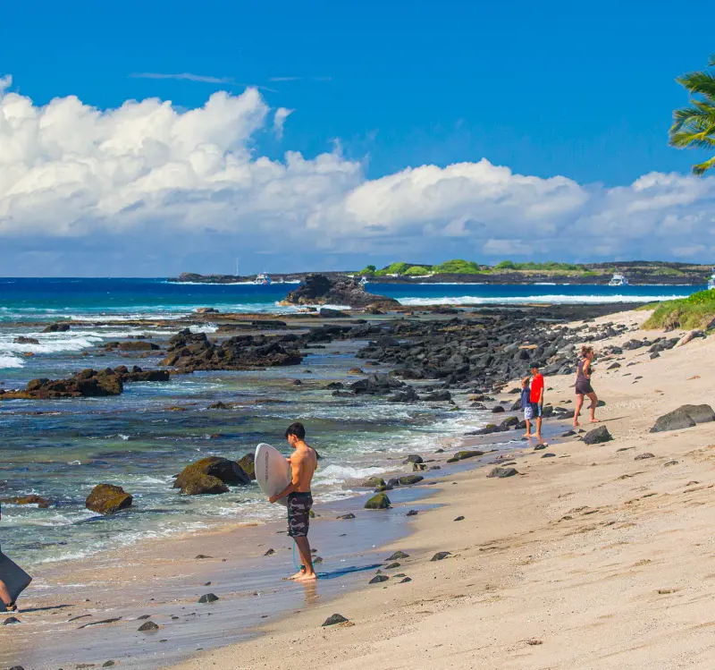 People ready to surf at the Old Kona Airport State Recreation Area