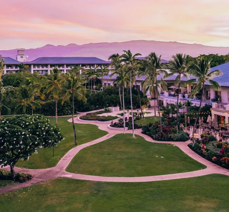 The bright building of Fairmont Orchid Hawaii and its golf course