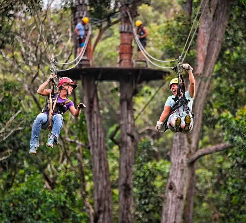 Two buddies take on an adventurous tour of the 1150-feet long zipline in Kohala, Hawaii