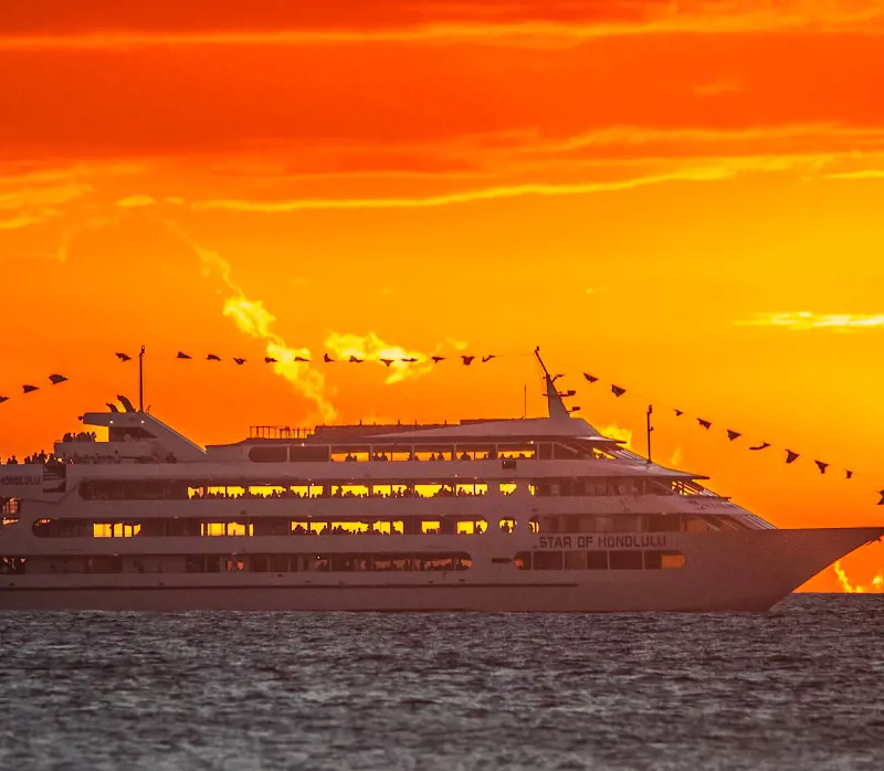 A passenger ship named Star of Honolulu sailing in the Hawaiian waters during the sunset
