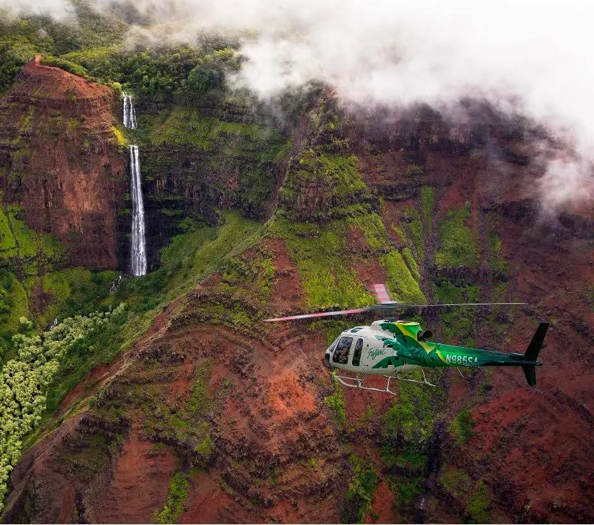 A chopper from Safari Helicopters flying above the beautiful landscape of Hawaii