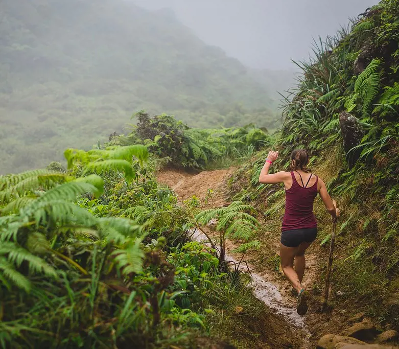A hiker walking downhill via Waihee Ridge Trail on Maui