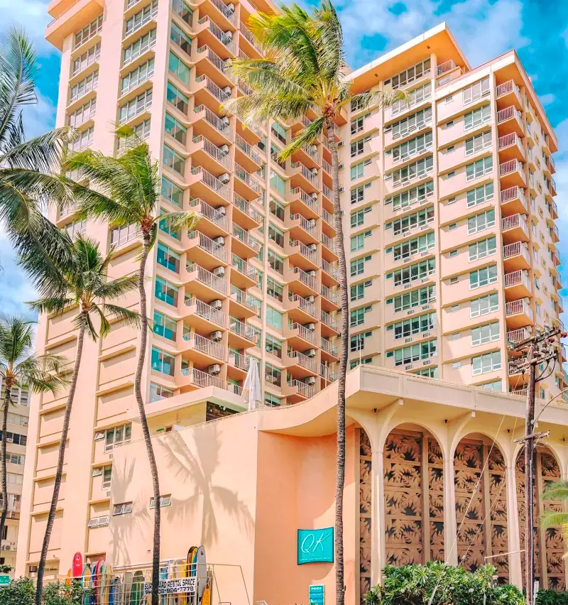 The beautiful and brighly-colored building of Queen Kapi’olani Hotel Waikiki Beach