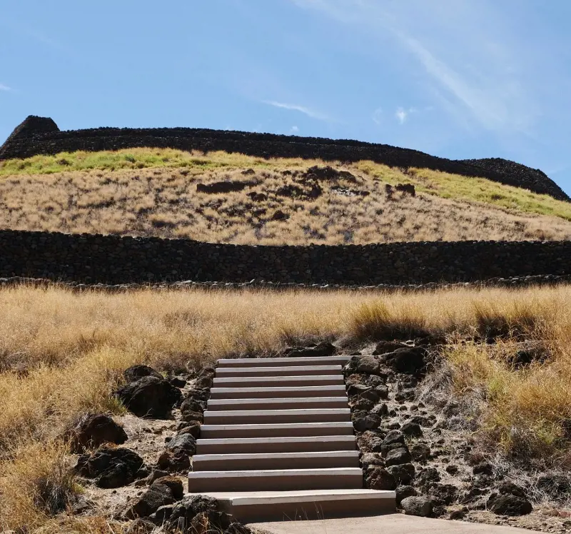 The trail at Pu'ukohola Heiau National Historic Site and the stone walls in the background