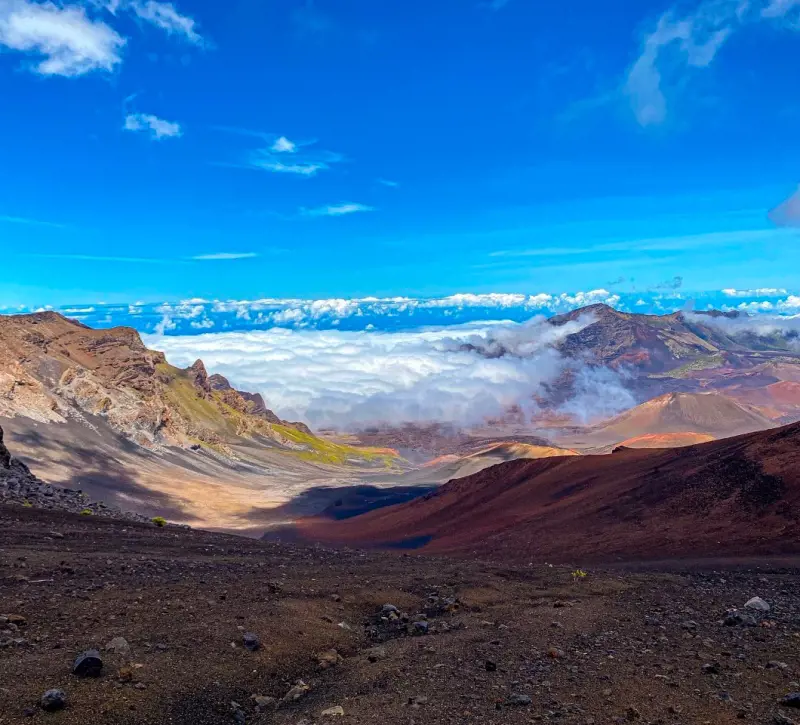 A bright day in Haleakala National Park with clouds over the hills