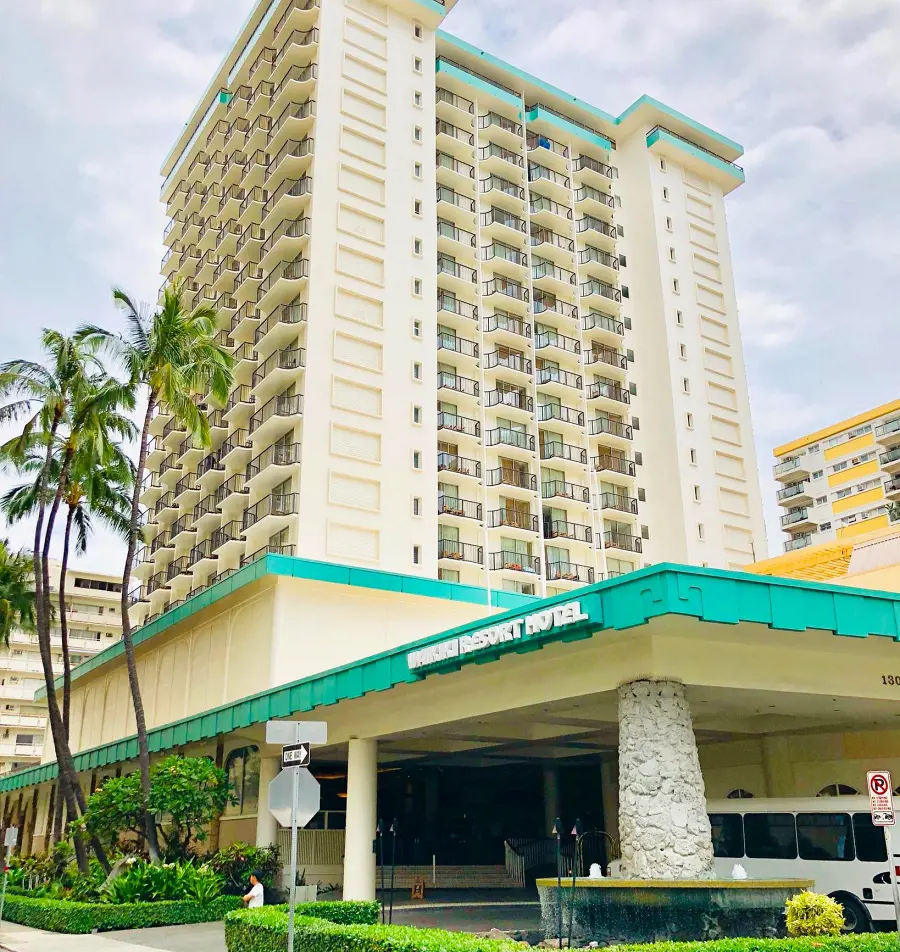 The brightly colored buiilding of Waikiki Resort Hotel and its entrance
