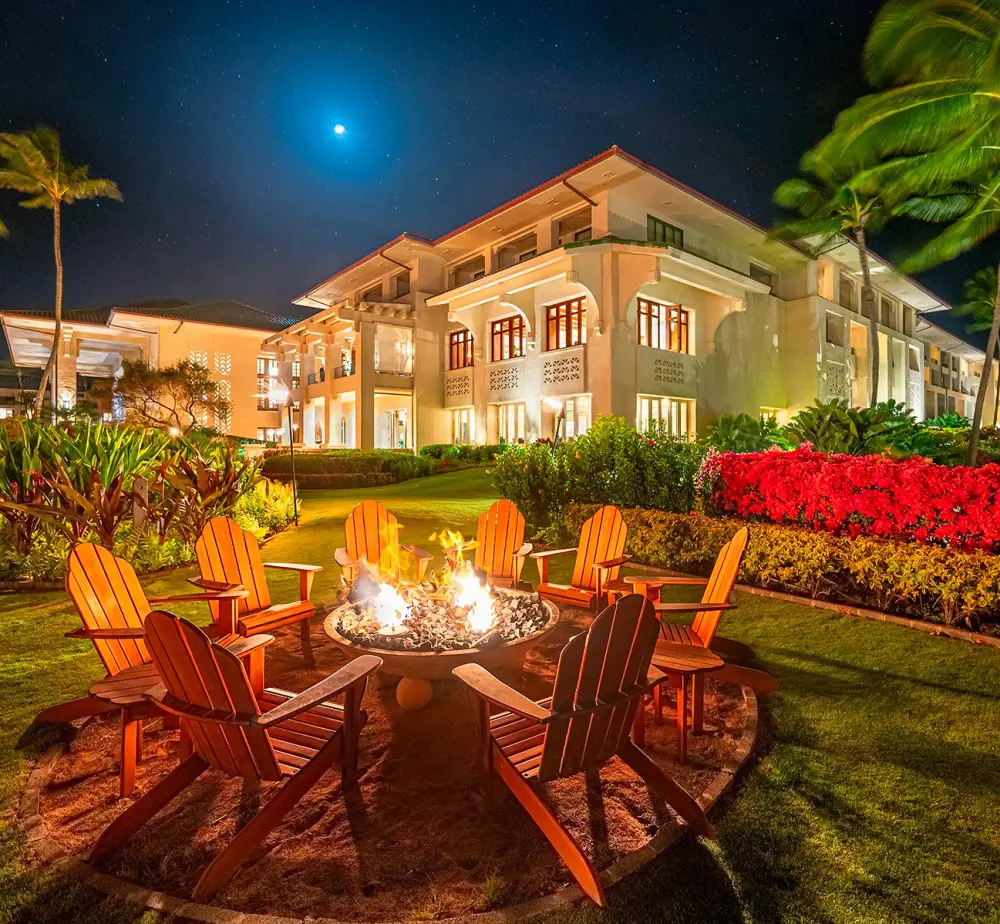 The perfect firepit and a well lit building of Grand Hyatt Kauai Resort & Spa on a full moon night in 2021