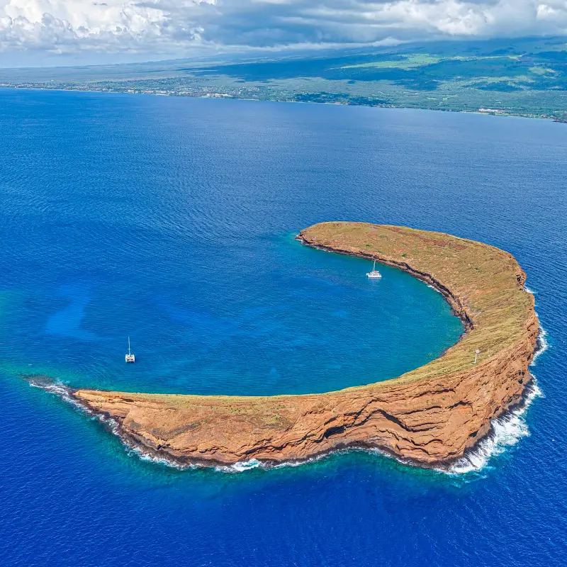An aerial view of the unique crescent shaped Molokini Crater in Maui