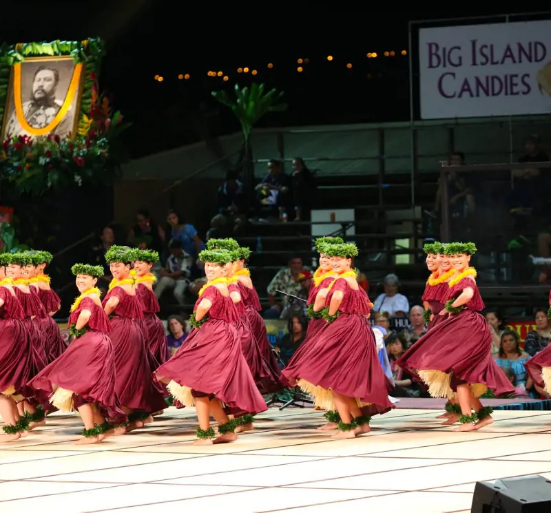 Performer dressed in Hawaiian attire perform at Merrie Monarch Festival