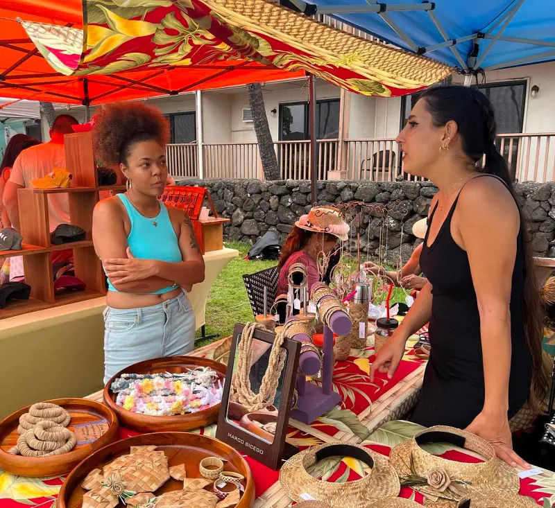 A lady puts up a stall with various items during the Kona Coffee Cultural Festival in 2022