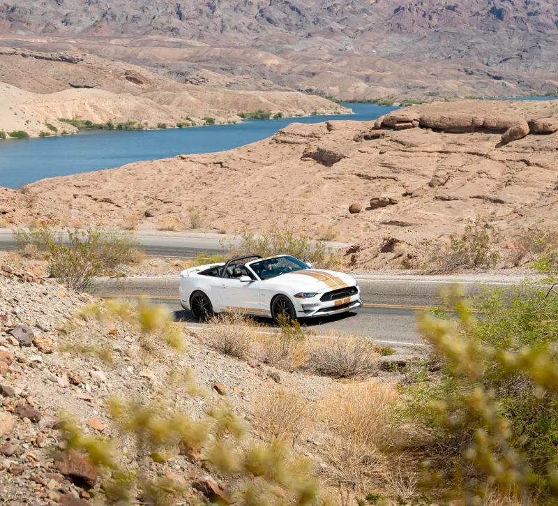 A white convertible from Hertz with a amazing view in the background