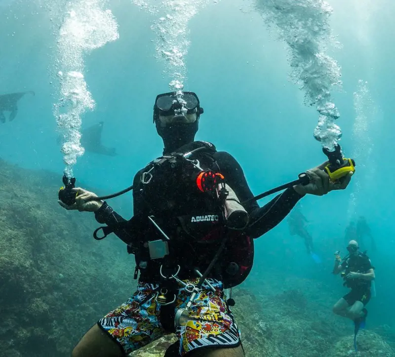 A scuba diver strikes a pose during an underwater expedition