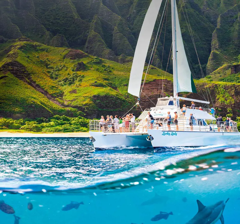 Tourists sailing on the 60-foot Catamaran named Lucky Lady in the Na Pali Coast