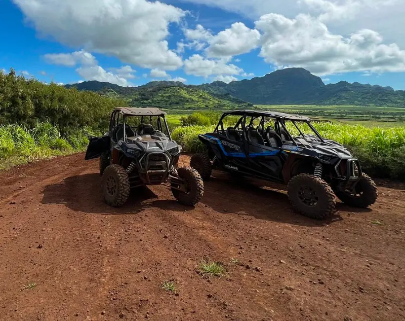 Two ATV parked in a rural location in Kauai with a beautiful view