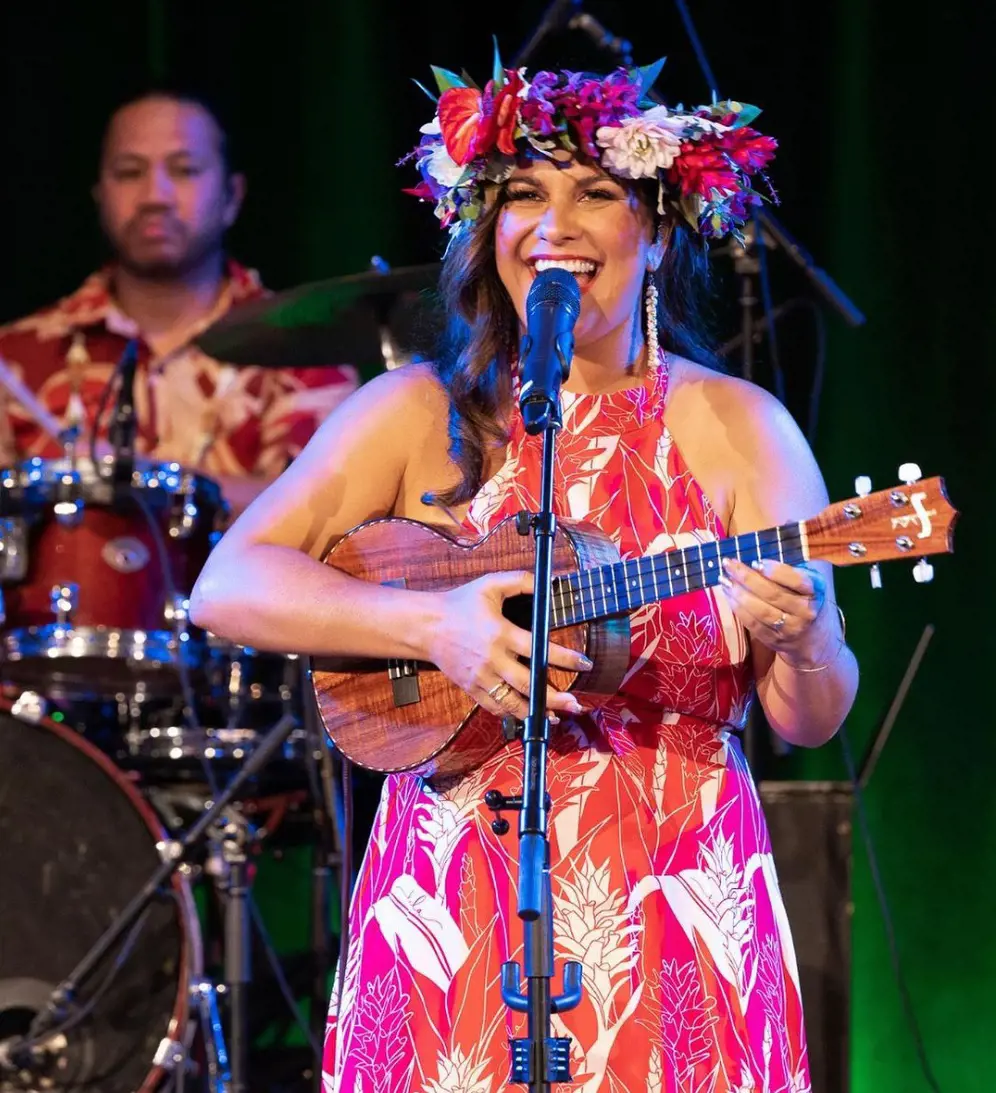 Kimie plays ukulele and performs at Hilo Town Market during her music tour