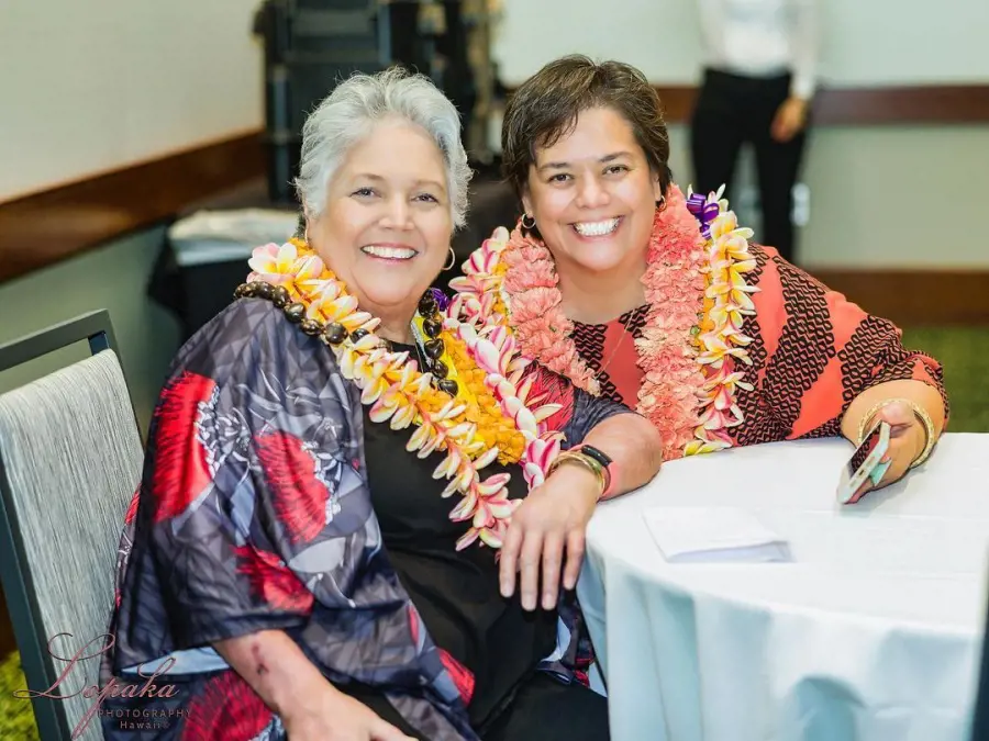 Ku'uipo [left] with a flower garland around her neck at Hawaii Convention Center in 2022