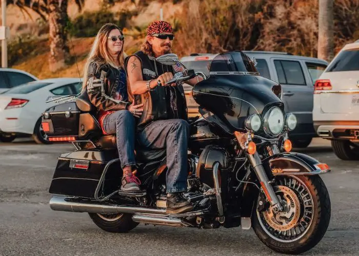 A couple touring Hawaii in a Harley Davison motorcycle