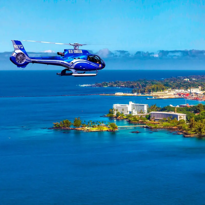 An eye-catching view of a passenger chopper from Blue Hawaiian Helicopters flying over the Hawaiian waters 