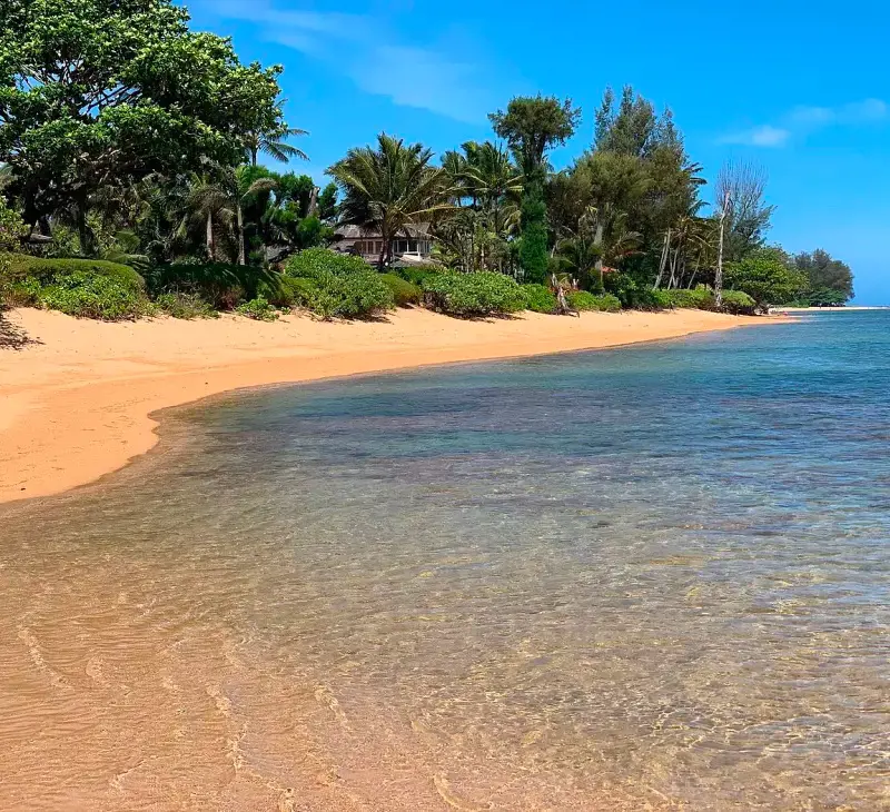The secluded and picturesque Anini Beach at Princeville, Kauai with calm ocean conditions
