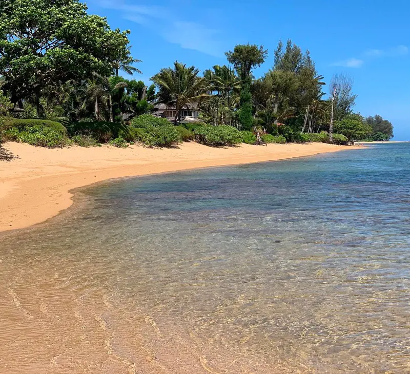 The secluded and picturesque Anini Beach with calm waters