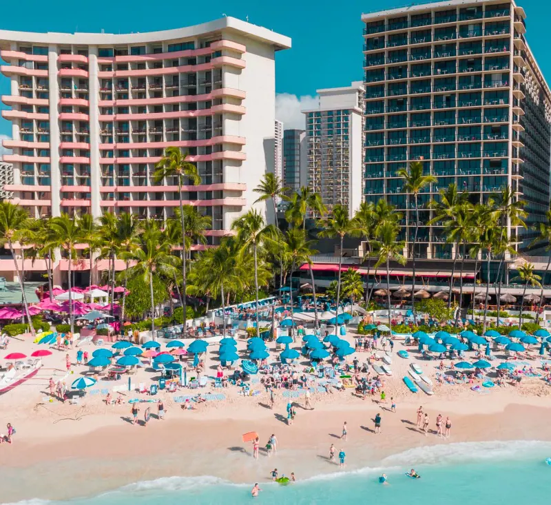 The famous Outrigger Waikiki Beach Resort and a bustling scene of the Waikiki Beach